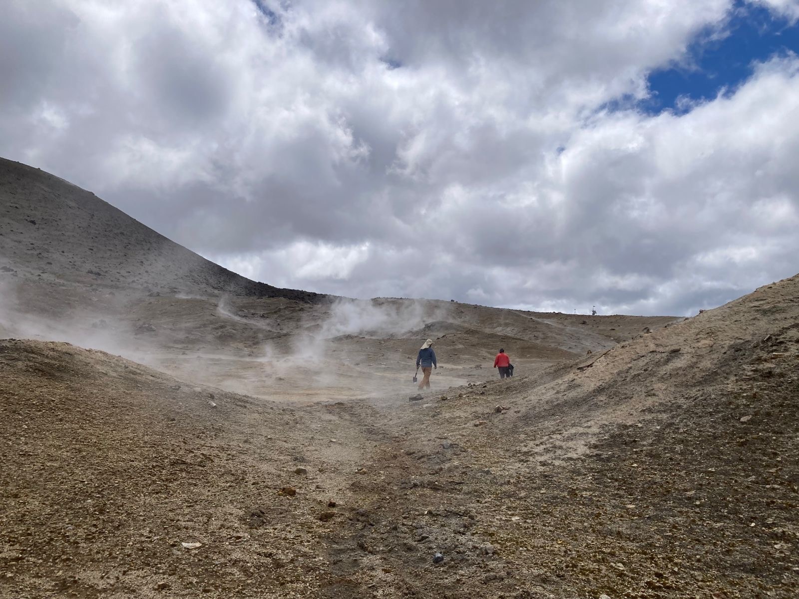 Field team walking across steaming ground at Cordón Caulle